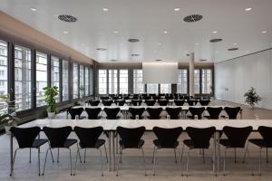 a large conference room with a large table and chairs at Hilton Garden Inn Davos in Davos