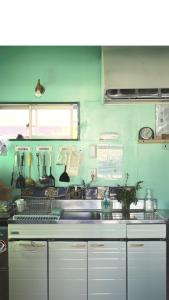 a kitchen with a sink and a counter at PavilionSurf&Lodge in Shishikui