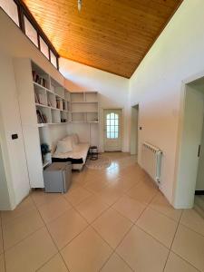 a living room with a bed and a wooden ceiling at Drini river view in Shkodër
