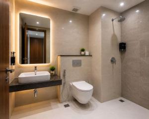 a bathroom with a toilet and a sink and a shower at Hotel Luxe Elite IGI Delhi in New Delhi