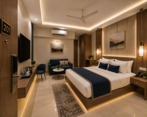 a hotel room with a bed and a living room at Hotel Luxe Elite IGI Delhi in New Delhi
