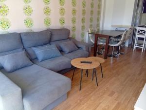 a living room with a couch and a table at Apartamento en Playa de Altar in Barreiros