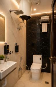 a bathroom with a toilet and a sink at Royal Awadh Inn Near Shree Ram mandir in Ayodhya +43 photos