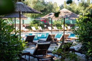 a group of chairs and umbrellas next to a pool at Veronica Hotel in Paphos