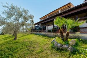 a house with palm trees in front of it at Villa Mapa - Appartamenti Lorusso in Vieste