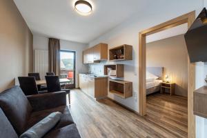a living room with a couch and a bed at Aparthotel Feldhof Nature in Bolzano