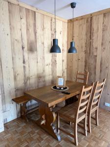 a dining room with a wooden table and chairs at Bardonecchia Holidays in Bardonecchia +18 photos