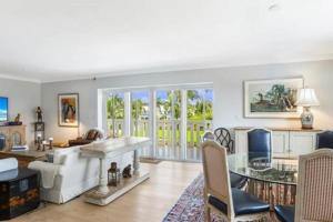 a living room with a fireplace and a table at Two Bedroom Bayfront Condo with Water Views in Naples