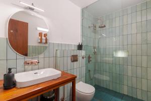 a bathroom with a sink and a toilet and a mirror at Over The World in Rāmgarh