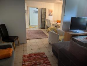 a living room with a couch and a flat screen tv at Appartement Julis 1 in 3430 Tulln in Tulln