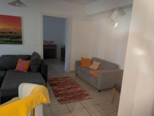 a living room with a couch and a chair at Appartement Julis 1 in 3430 Tulln in Tulln +1 photo