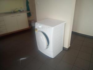 a washing machine in a room with a tile floor at Mesta Room in Gotse Delchev +4 photos
