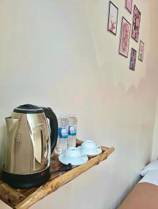 a coffee maker on a wooden shelf on a wall at Nấm Homestay in Sapa