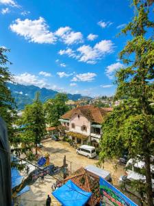a view of a town with mountains in the background at Nấm Homestay in Sapa