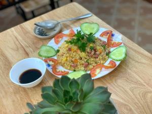 a plate of food with peppers and rice on a table at Nấm Homestay in Sapa