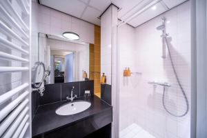 a bathroom with a sink and a shower at Hotel Wesseling in Dwingeloo +42 photos