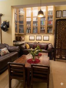 a living room with a table and a couch at Nilayam guest house in Patna