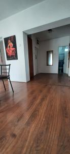 an empty room with a wooden floor in a building at Apartman Dejanović 1 in Veliko Gradište