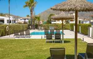 a group of chairs and umbrellas next to a pool at La Perla Puerto Pollença 9 in Pollença +16 photos