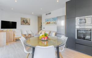 a kitchen and living room with a table and chairs at La Perla Puerto Pollença 9 in Pollença