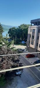 a view of a street with a building and a parking lot at Apartman Dejanović 1 in Veliko Gradište