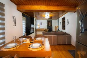 a dining room with a table and a couch at Joanna's House in Koumaradaíoi