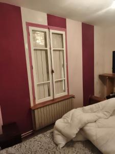 a bedroom with a bed and a window at Chambre pèlerinage in Saint-Hilaire-la-Palud