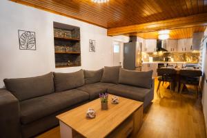 a living room with a couch and a table at Joanna's House in Koumaradaíoi
