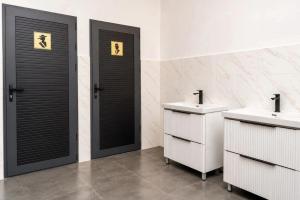 a bathroom with two sinks and two toilets at Datka Hotel in Bishkek +16 photos