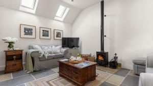 a living room with a couch and a fireplace at Applewood in Harome