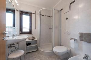 a bathroom with a shower and a toilet and a sink at Aparthotel Feldhof Nature in Bolzano +30 photos