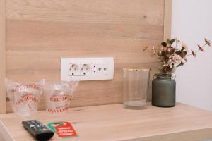 a shelf with a remote control and a vase on it at Sobe B&M Livno in Livno