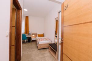 a room with a bedroom with a bed and a desk at Sobe B&M Livno in Livno +19 photos
