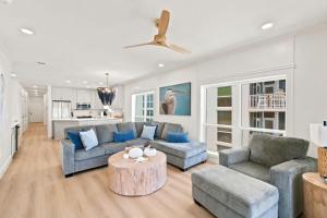 a living room with two couches and a table at Riviera Dunes 501 in Perdido Key