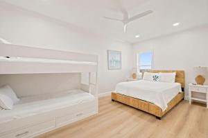 a white bedroom with two bunk beds in it at Riviera Dunes 501 in Perdido Key +38 photos