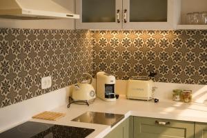 a kitchen with a sink and a counter top at Athena Collection in Kefalos +47 photos