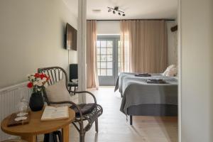a hotel room with a bed and a table and a table at Gumbalde Resort in Stånga +96 photos