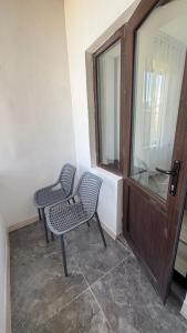 two chairs sitting in front of a door at Guest House Alim in Karakol +43 photos