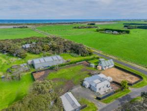 an aerial view of a farm with buildings and the ocean at Tranquillity by the sea in Killarney