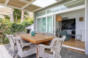 a patio with a wooden table and chairs at Views Spacious Villa in El Rincón