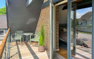 a patio with a table and chairs on a balcony at Awesome Home In Haderslev With Sauna in Haderslev +24 photos
