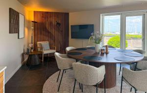 a living room with a dining room table and chairs at Awesome Home In Haderslev With Sauna in Haderslev