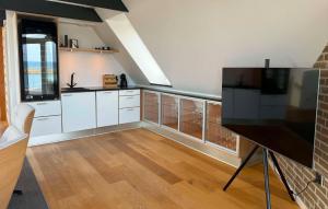 a kitchen with white cabinets and a large window at Awesome Home In Haderslev With Sauna in Haderslev