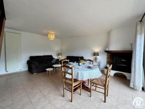 a living room with a table and chairs and a couch at Rafael in Quintillan