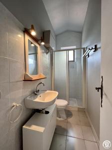 a bathroom with a sink and a toilet and a shower at Rafael in Quintillan
