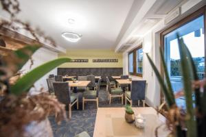 a restaurant with tables and chairs and a window at Aparthotel Feldhof Nature in Bolzano