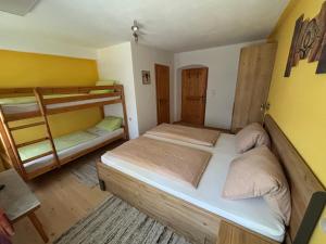 a room with two bunk beds in it at Haus Falkner in Mutters