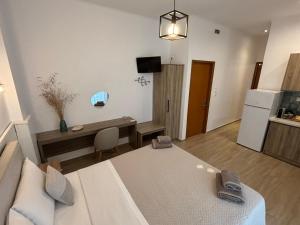 a living room with a couch and a table and a refrigerator at ILIOVASILEMA - Ηλιοβασίλεμα in Pefki