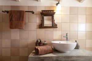 a bathroom with a sink and a mirror at Villa Aposperitis in Panormos Rethymno +206 photos
