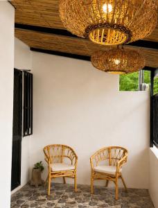 two chairs under a ceiling with a chandelier at Casa Aelliah in General Santos +2 photos